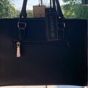 La Terre black 2 in one purse trimmed in gold. Great bag for Christmas.